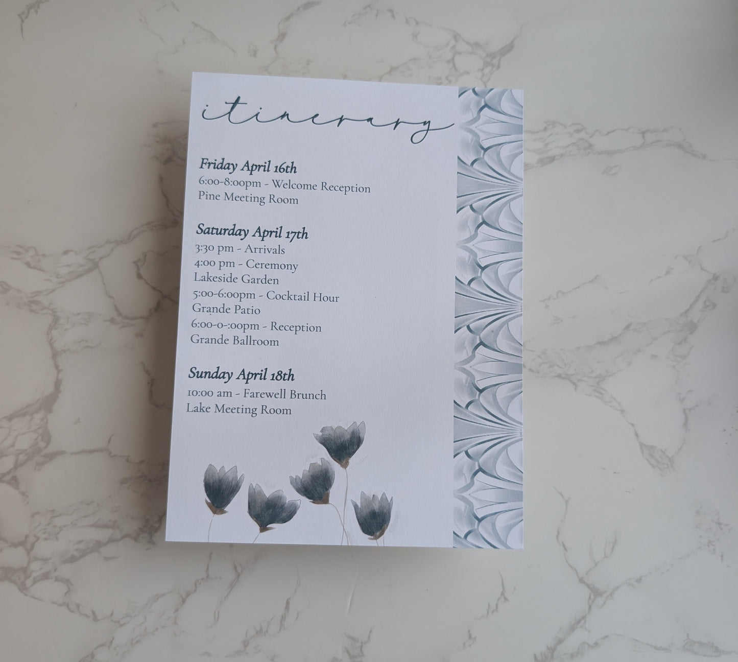 Invitation card with event details on a marble surface