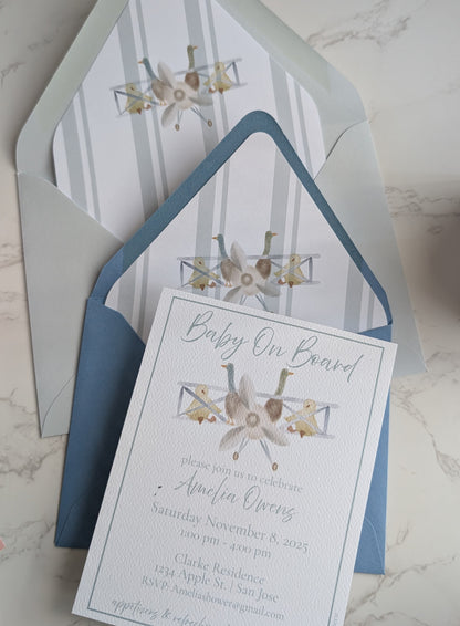 Baby shower invitation with envelope on a marble surface