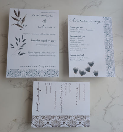 Set of wedding invitations with floral designs on a marble surface