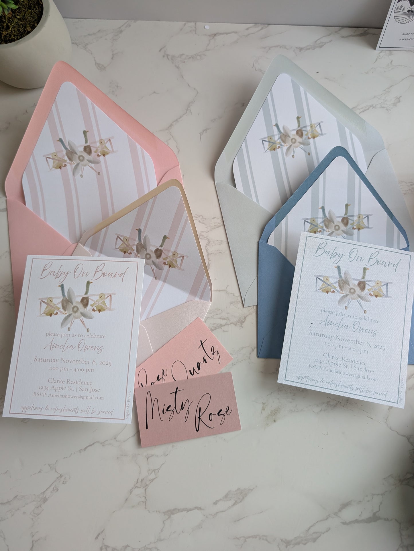 Baby shower invitations with envelopes on a marble surface