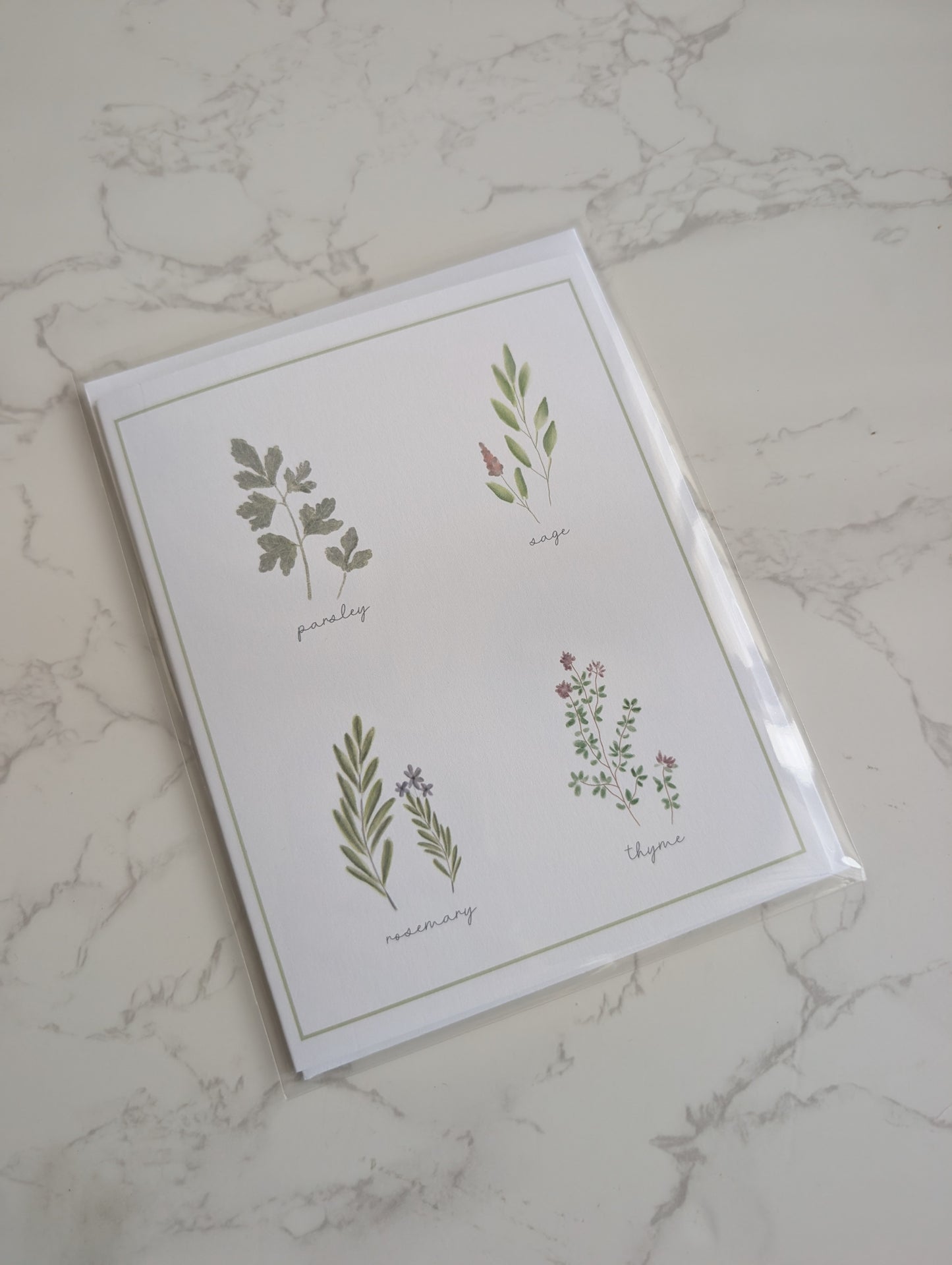 Card with botanical illustrations on a marble surface