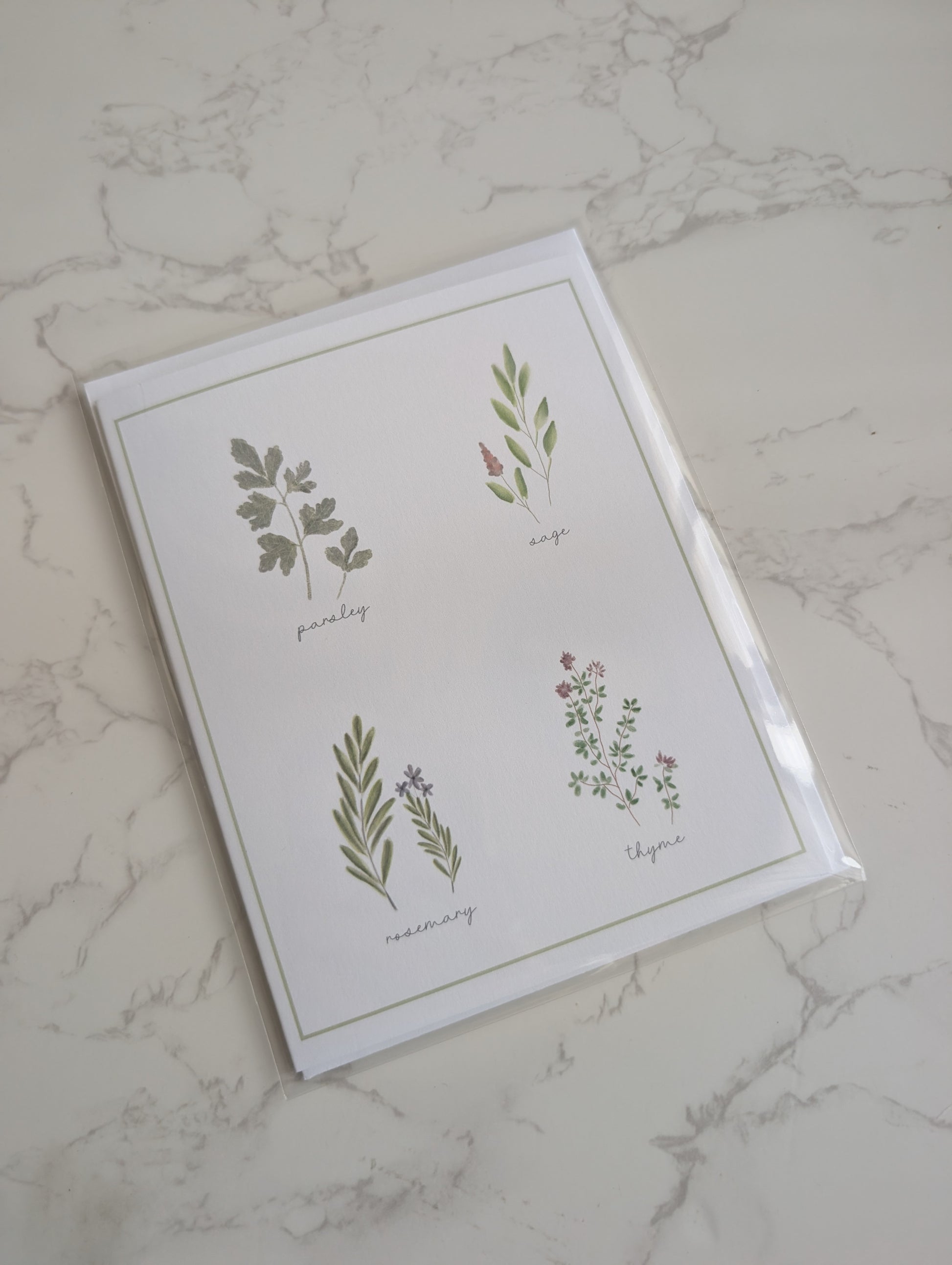 Card with botanical illustrations on a marble surface