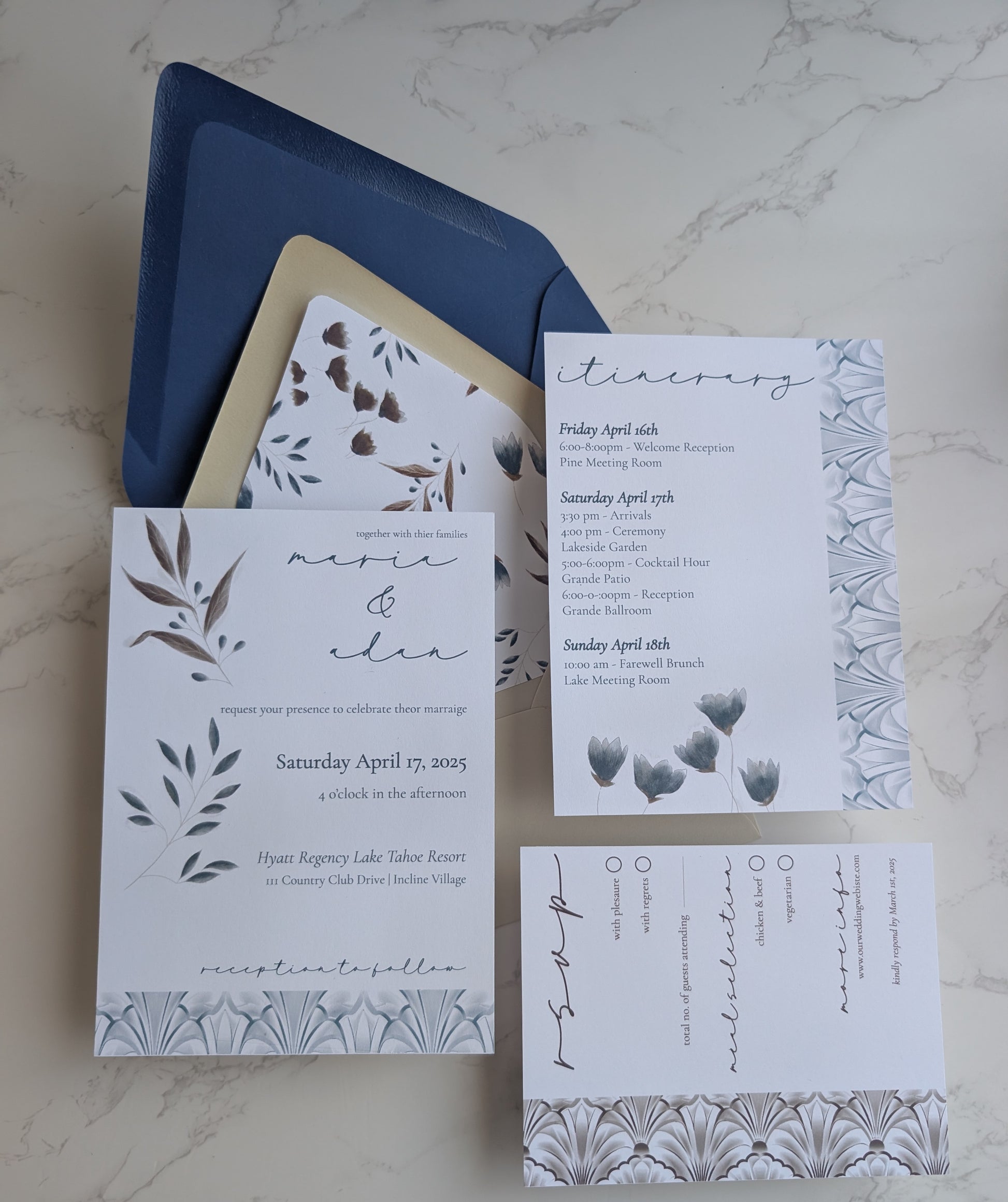 Set of wedding invitations with floral designs on a marble surface