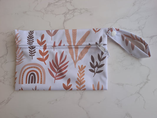 Fabric pouch with leaf pattern on a marble surface