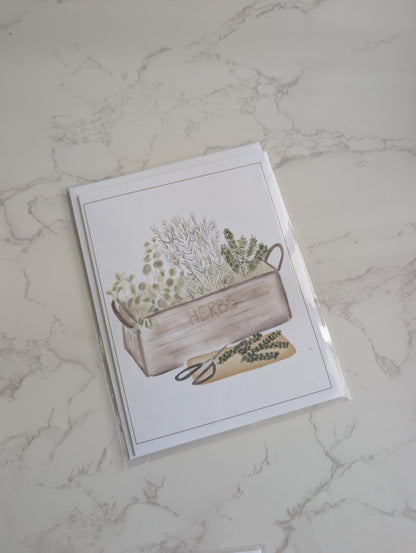 Greeting card with a wooden crate and plants design on a marble surface