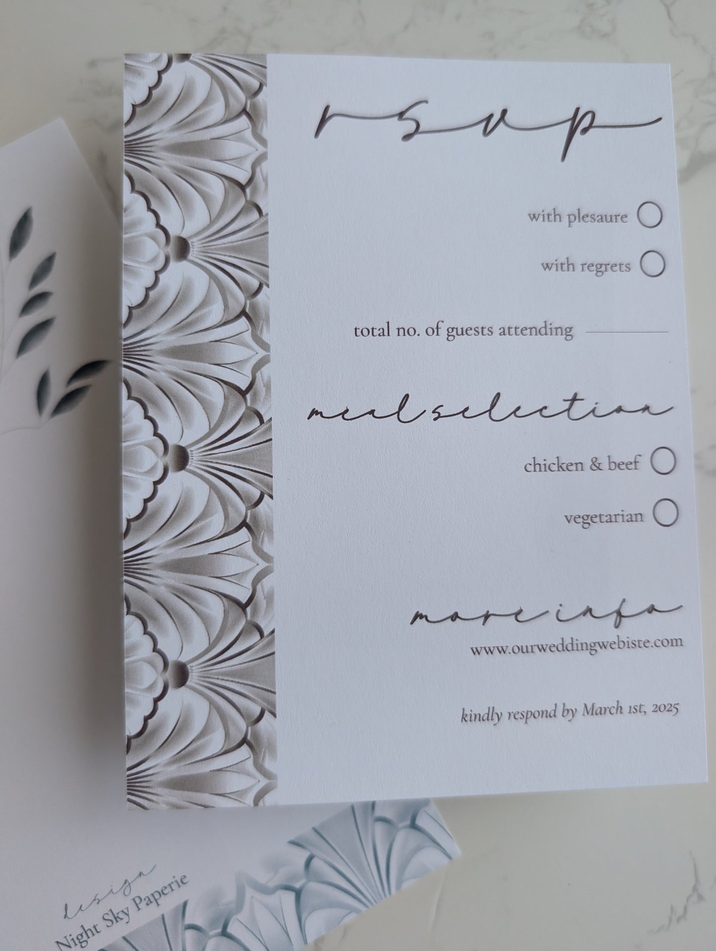 White RSVP card with floral pattern on the left side
